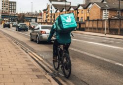deliveroo cyclist on road cycling