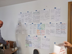 Written post-it notes on a board - Brainstorming for community building in July 2022