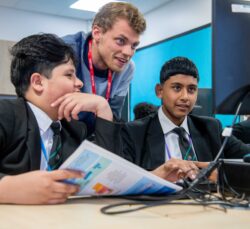 16 May 2023. University of Leeds’ Institute for Data Analytics (LIDA) members took their Data Scientist Development Programme to Carlton Keighley Secondary School. Owen Higgert with students working on one of the projects.