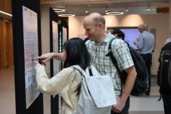 Delegates pointing at posters on display during the events networking lunch