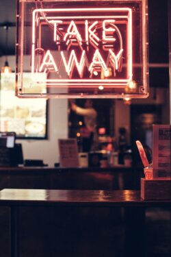 View looking into a takeaway shop with neon sign