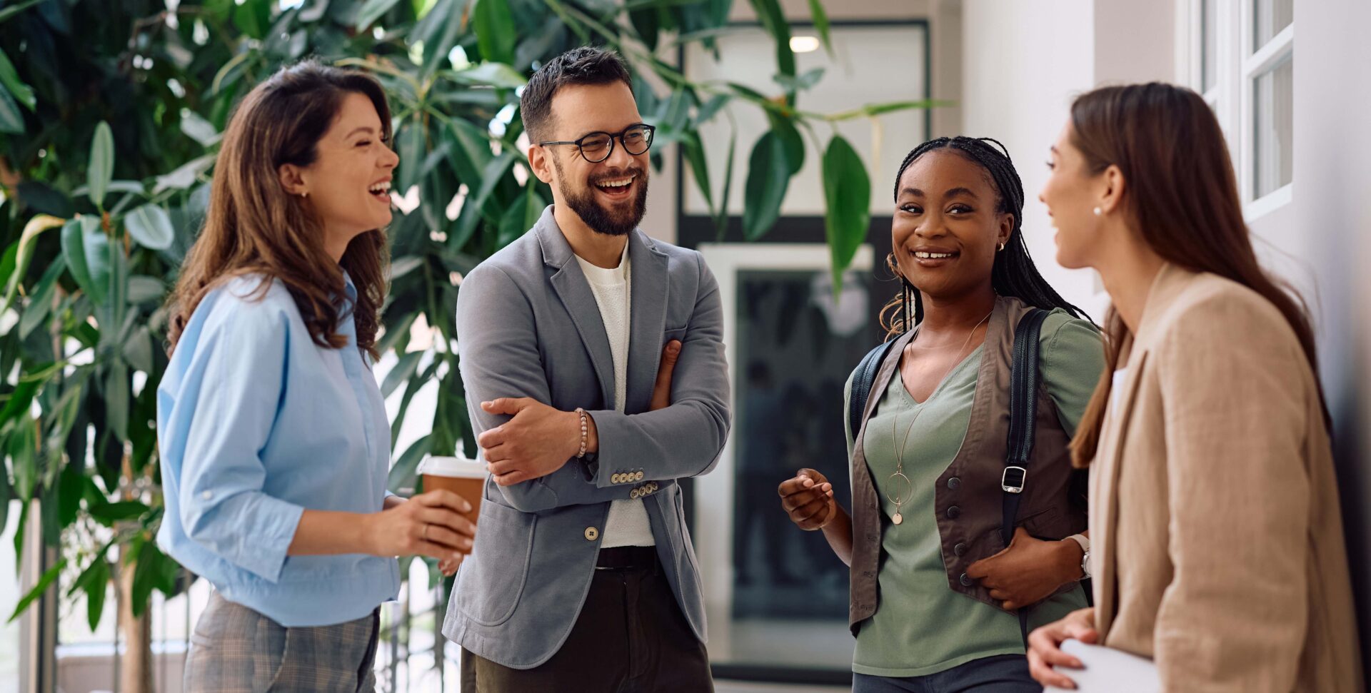 Group of young professionals stood chatting